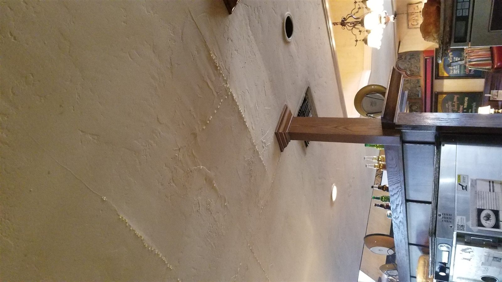 Busy restaurant interior showing maintenance work above the kitchen
